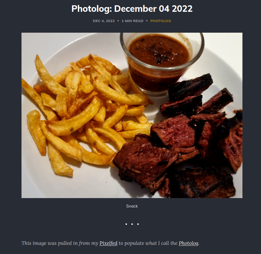 Screenshot of a photolog post: It has an image of a plate of food - fries, fake stea, sauce in a little glass container - and below it the caption "Snack". Below a divider the text: "This images was pulled in from my Pixelfed to populate what I call the Photolog."