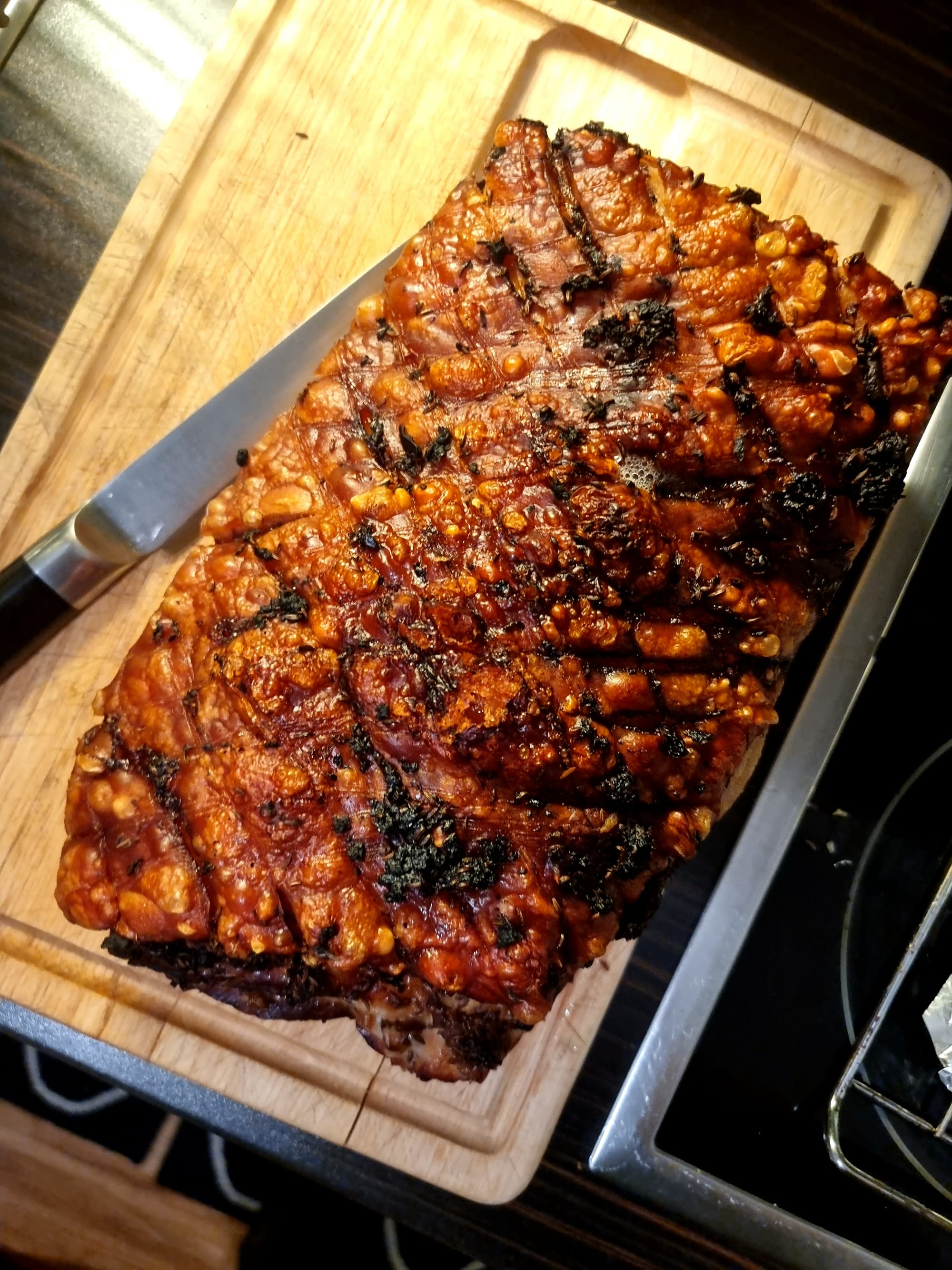A pork with plenty of crackling on a wooden board