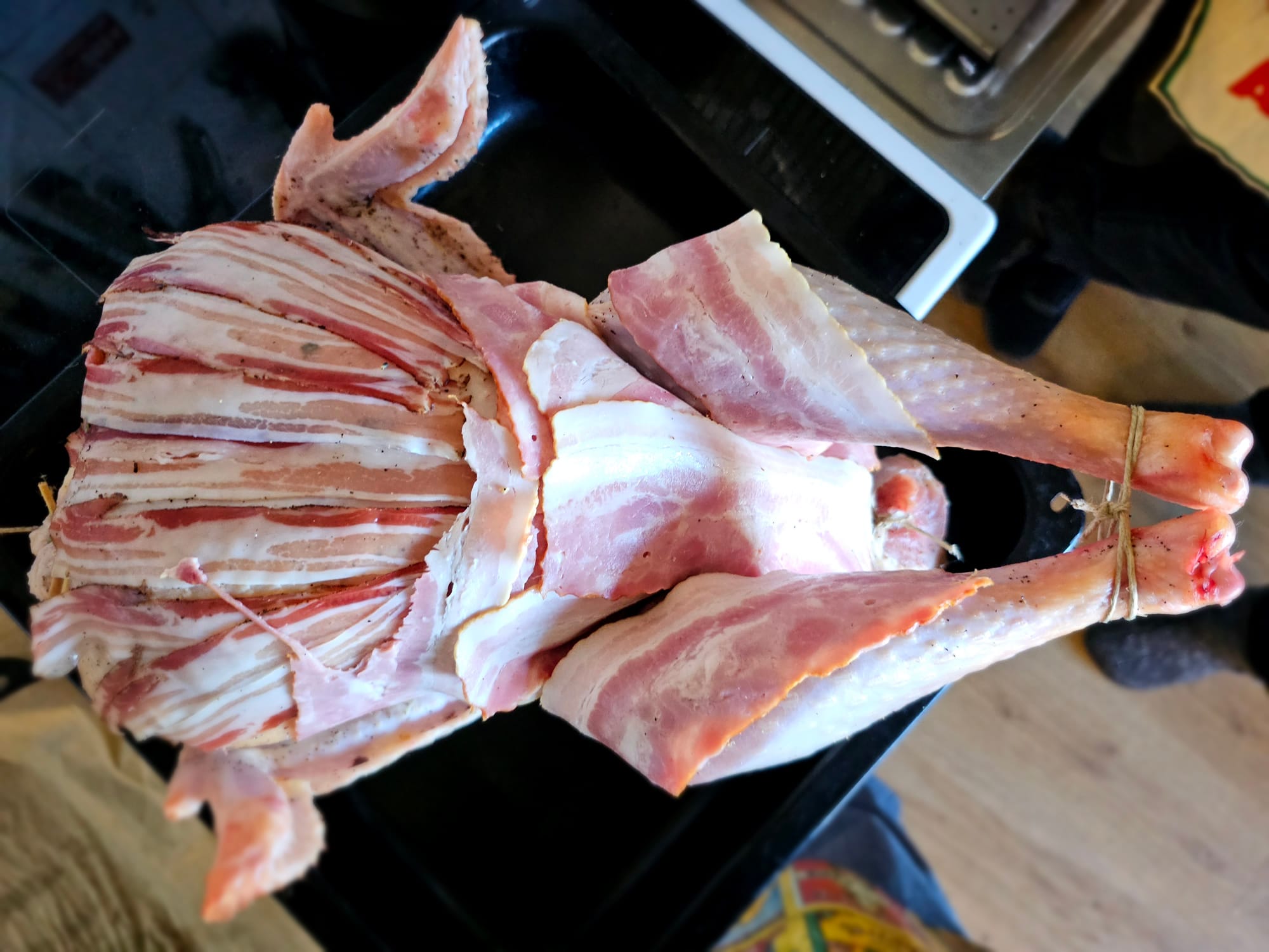 A turkey dressed in bacon, ready for the oven 