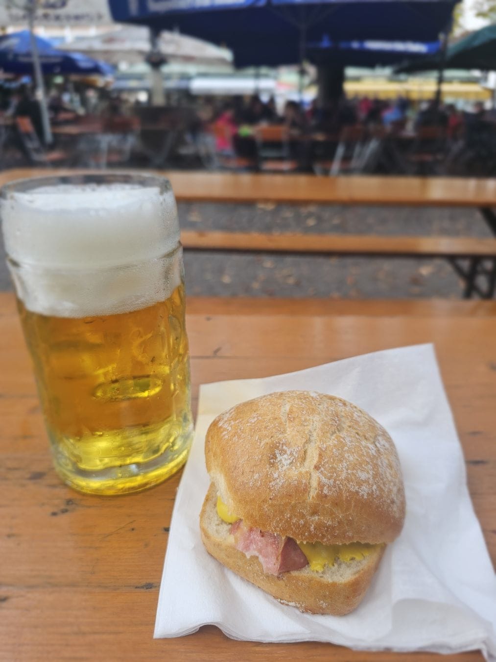 A cheese leberkassemmel with beer, in a beer garden in Munich