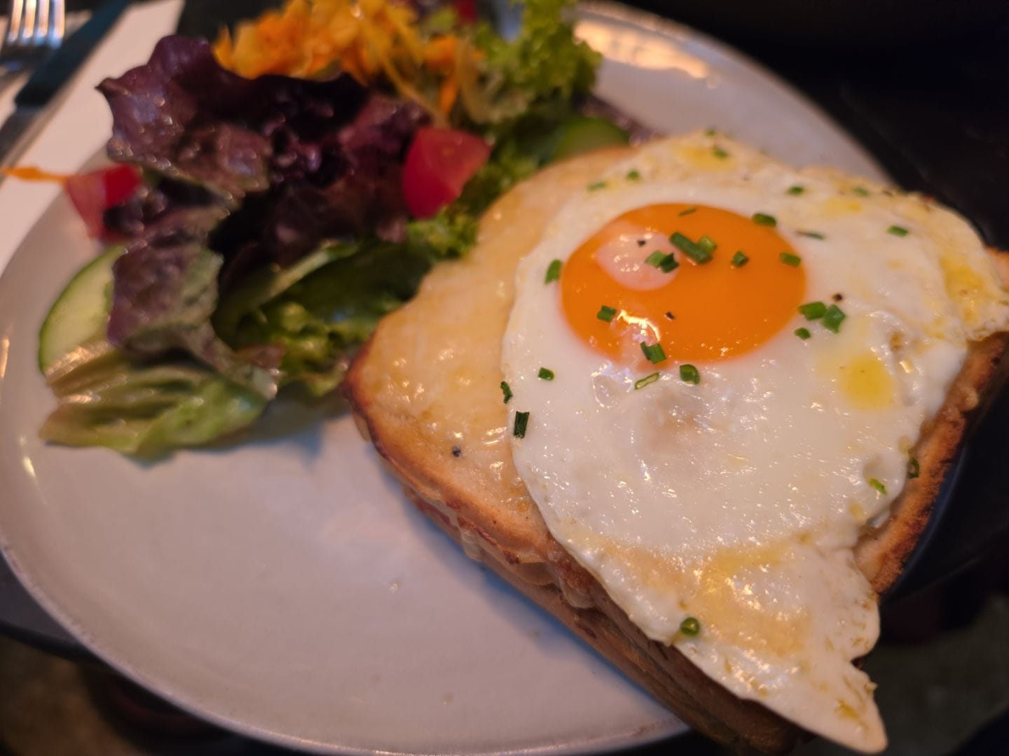 A Croque Madame (ham and cheese toast with bechamel and a fried egg on top)