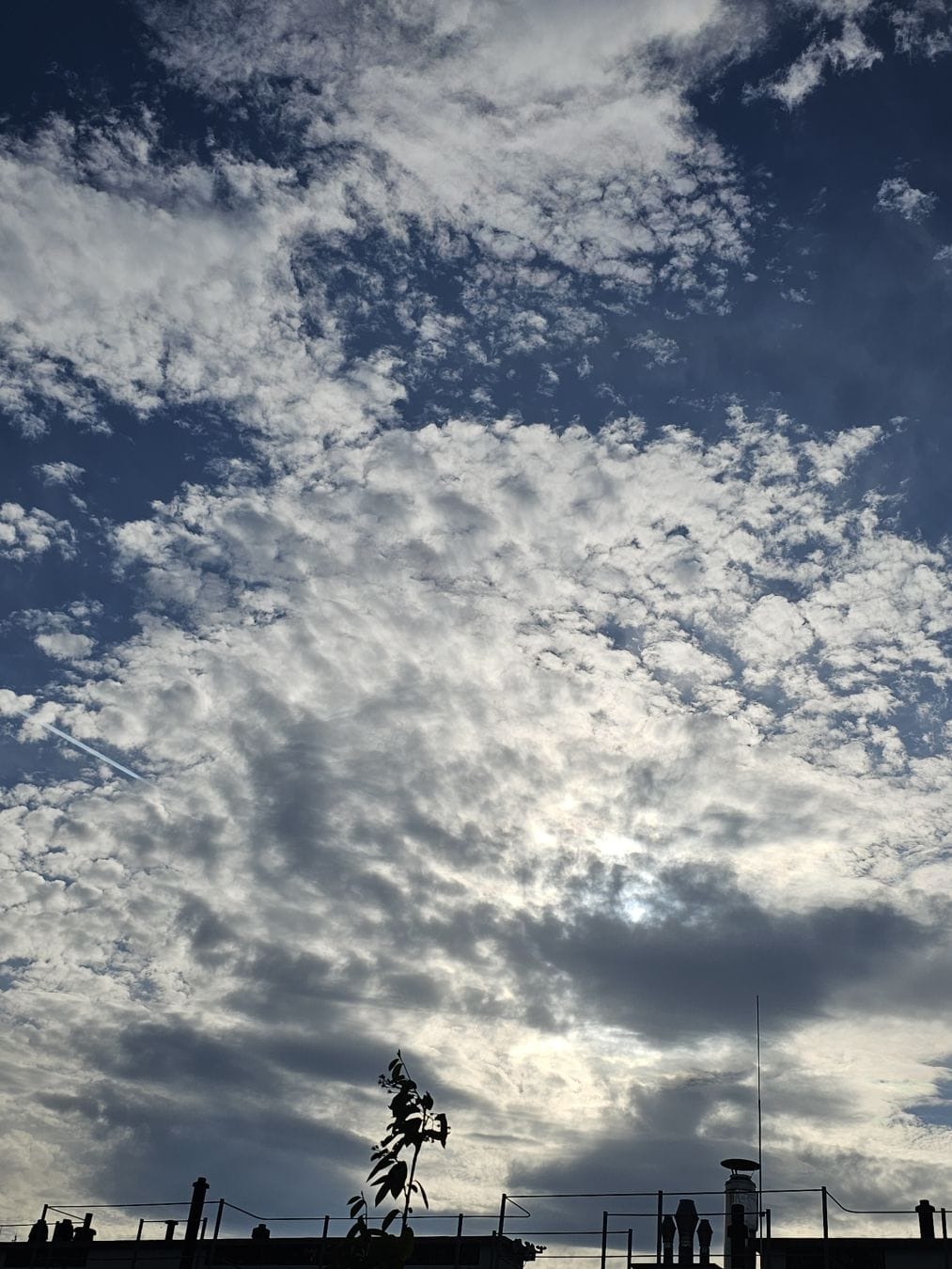 Illuminated clouds above a rooftop